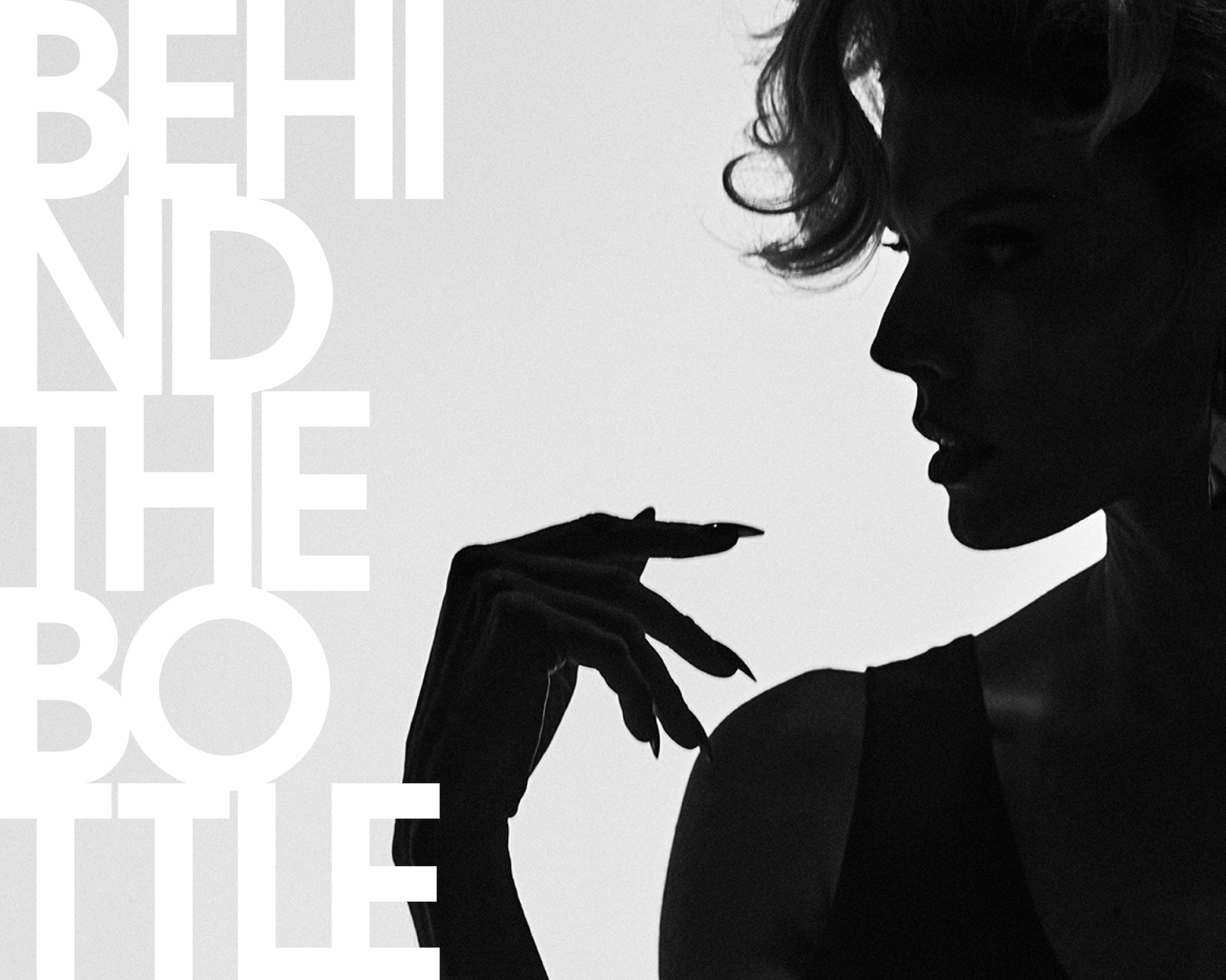 Black and white editorial-style image with large white text reading 'BEHIND THE BOTTLE' and a silhouetted woman in profile